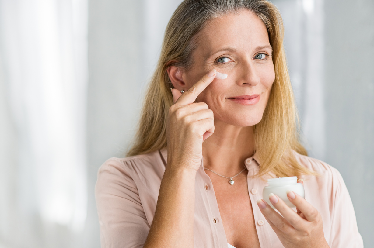Woman Applying anti Aging Lotion on Face